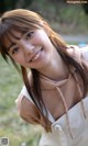 A young woman with long brown hair smiles at the camera.